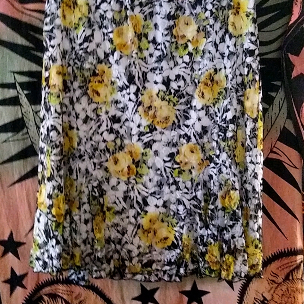 Yellow flowered black and white flowing skirt .